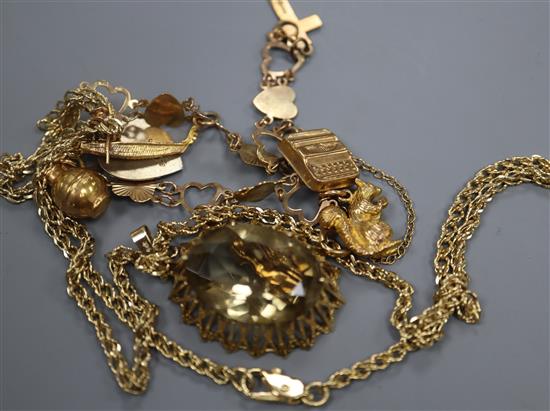 A gold and silver charm bracelet hung with seven charms and a citrine pendant in 9ct gold openwork setting,